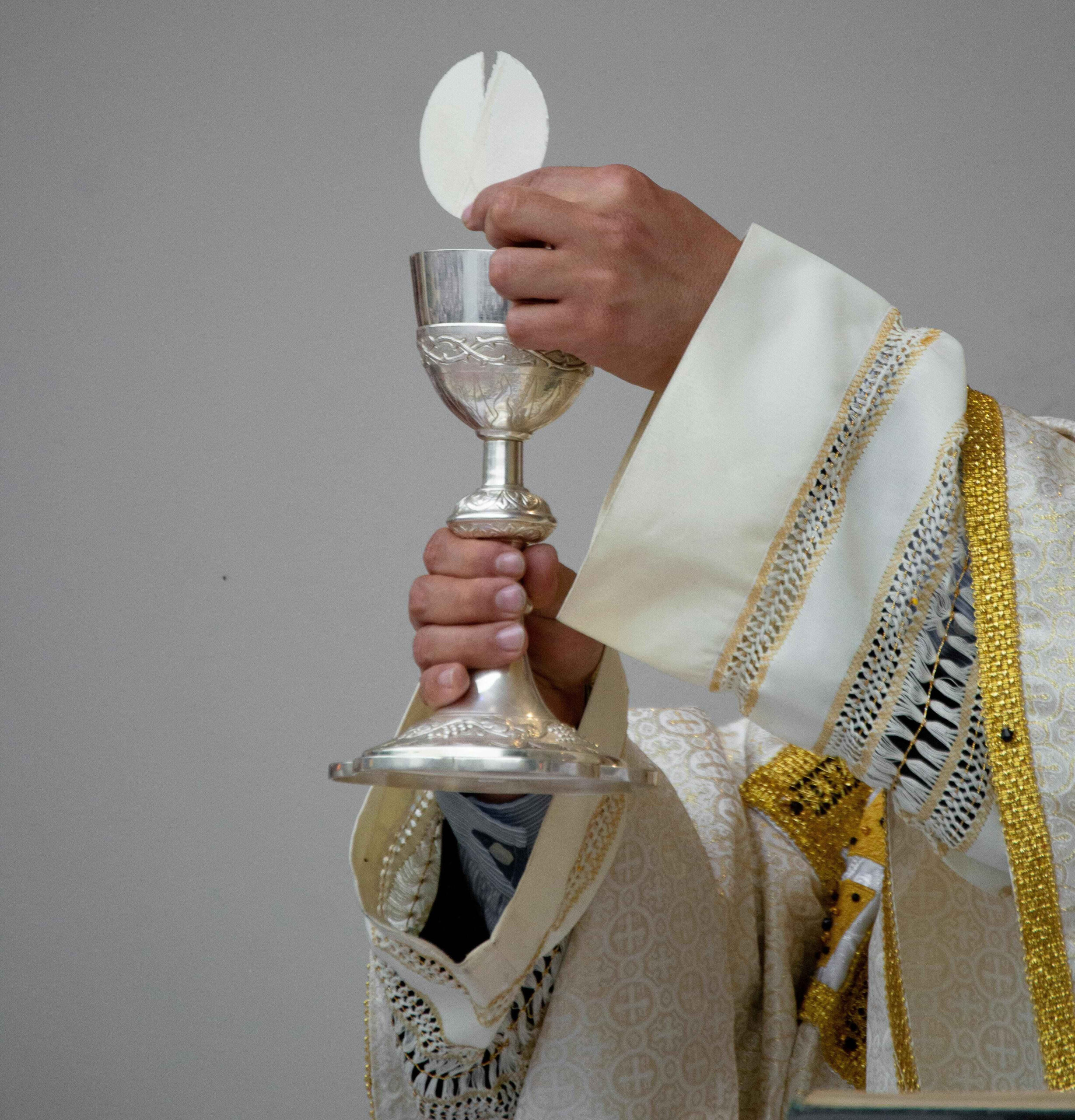 Priest elevating the chalice during the Holy Mass